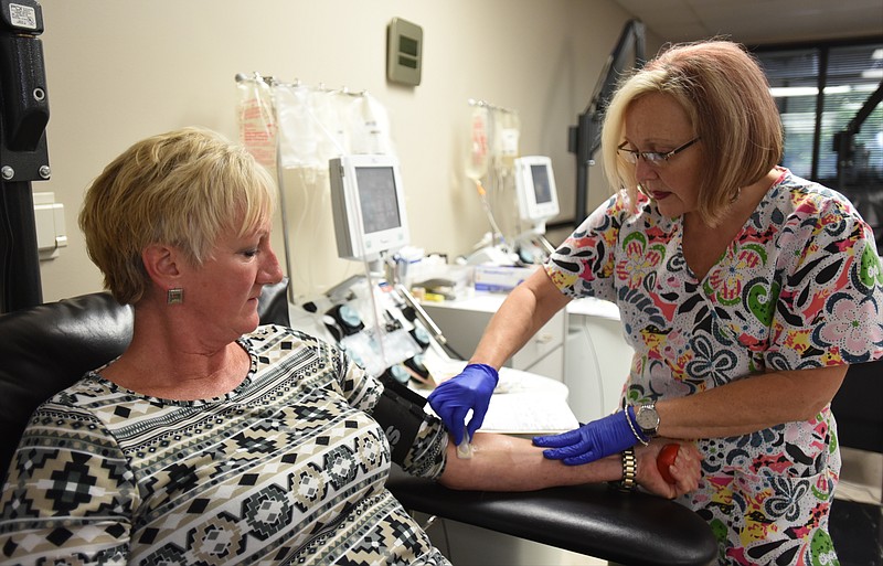 Sheliah Henley prepares Caroline Chipley Johnson's arm to donate platelets at Blood Assurance in Chattanooga.