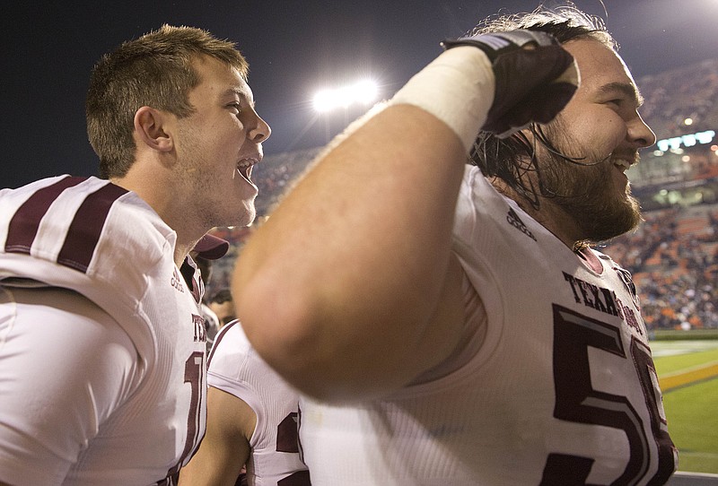 Texas A&M center Mike Matthews raises his arm to celebrate along with Aggies quarterback Kyle Allen during the final stages of their 41-38 upset win at Auburn last November.