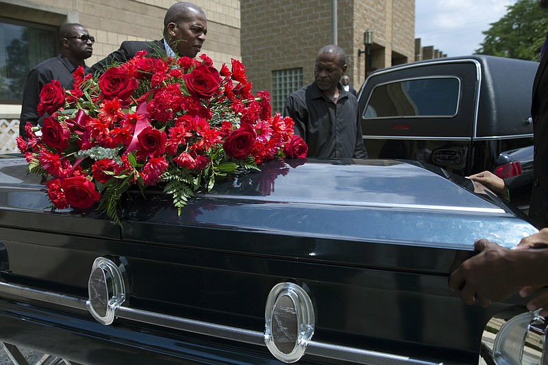 The casket of Samuel Dubose is transported to a hearse during his funeral at the Church of the Living God in the Avondale neighborhood of Cincinnati, Tuesday, July 28, 2015. Dubose was fatally shot by a University of Cincinnati police officer who stopped him for a missing license plate.