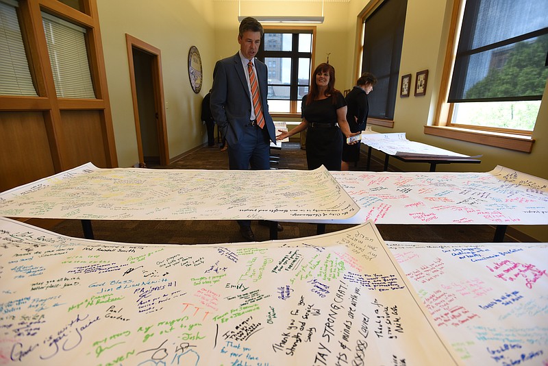 Leslie Robertson, with Revitalize Port Angeles, talks with Mayor Andy Berke Thursday, July 30, 2015 in City Hall after delivering supportive banners to Chattanooga. Chattanooga and Port Angeles battled for the top spot in Outside magazine Best Town contest.