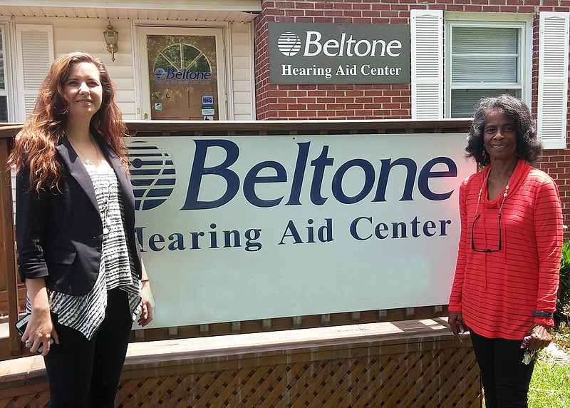 Jennifer Carson, left, Beltone director of business development, congratulates Connie Griggs, winner of a Beltone Promise hearing aid.