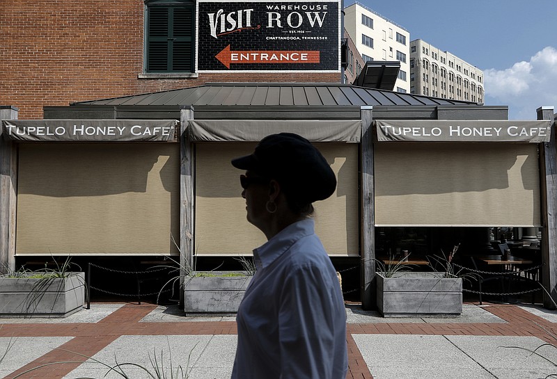 A shopper walks into Warehouse Row on Tuesday, July 28, 2015, in Chattanooga, Tenn.