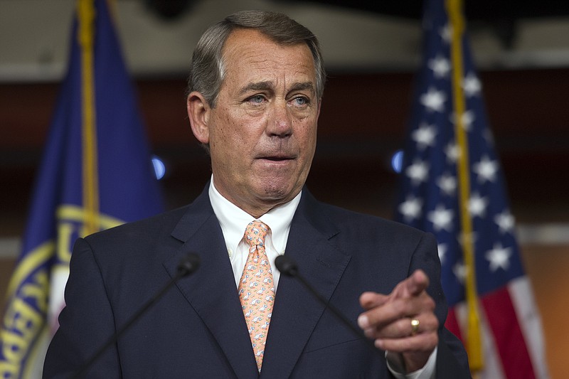 In this July 9 file photo, House Speaker John Boehner of Ohio gestures during a news conference on Capitol Hill in Washington.