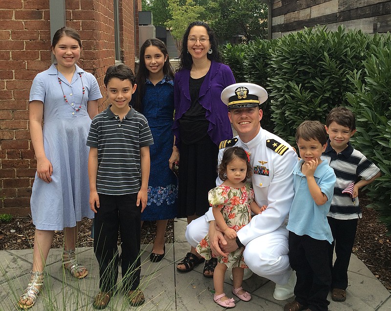 Lt Commander Timothy White is pictured with his family.