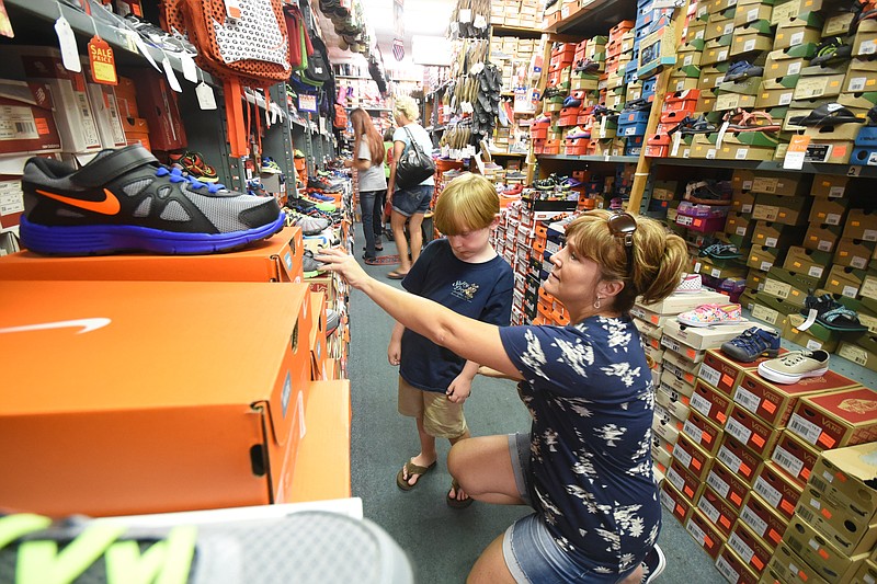 Susan Waskey looks for back-to-school shoes with her son, Nate, 6, Thursday at Sear's Shoe Store in Fort Oglethorpe.