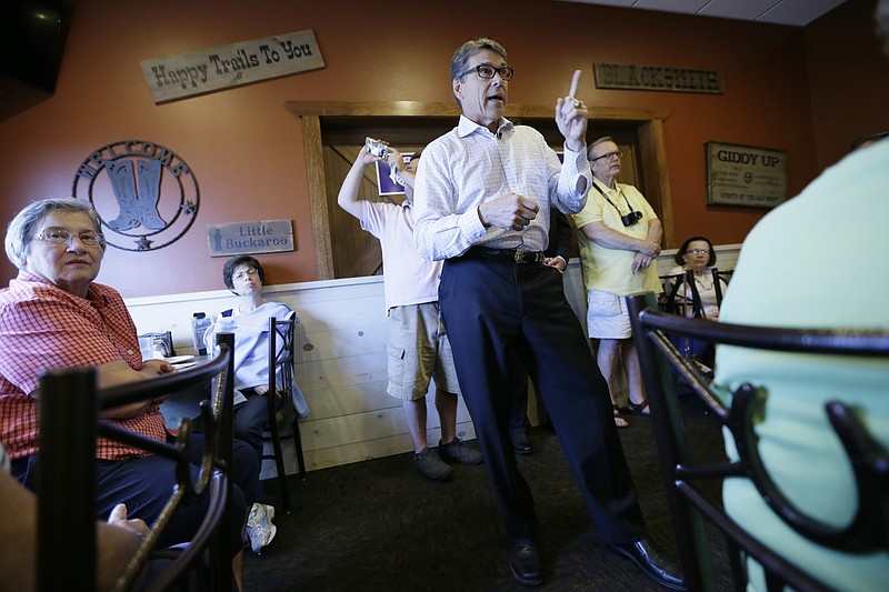 
              In this July 13, 2015, photo, Republican presidential candidate former Texas Gov. Rick Perry speaks during a meet and greet with local residents in Fort Dodge, Iowa. Perry's devout Christian beliefs were a centerpiece of his short-lived 2012 White House bid but are an afterthought in his second-chance campaign across Iowa. (AP Photo/Charlie Neibergall)
            