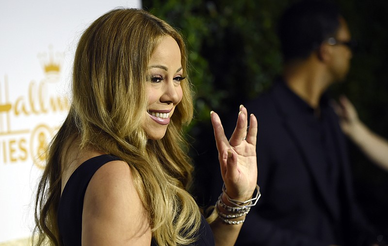 
              Mariah Carey waves to photographers at the Crown Media Family Networks Television Critics Association party on Wednesday, July 29, 2015, in Beverly Hills, Calif. (Photo by Chris Pizzello/Invision/AP)
            