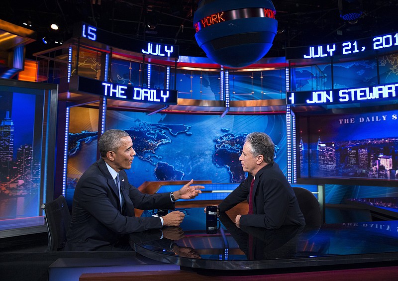 
              FILE - In this July 21, 2015 file photo, President Barack Obama, left, talks with Jon Stewart, host of "The Daily Show with Jon Stewart" during a taping in New York.  Stewart reacted to a Politico story headlined "Jon Stewart's Secret White House Visits." The article said Stewart had met with the president in 2011 and again last year. Stewart noted that he entered the White House through its public entrance and that both meetings were listed in the White House visitor logs, available for anyone to see. (AP Photo/Evan Vucci, File)
            