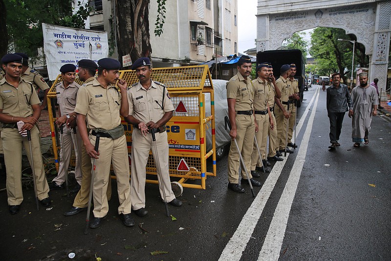 Indian policemen stand guard in the neighborhood of Yakub Abdul Razak Memon's family residence in Mumbai, India, Thursday, July 30, 2015.