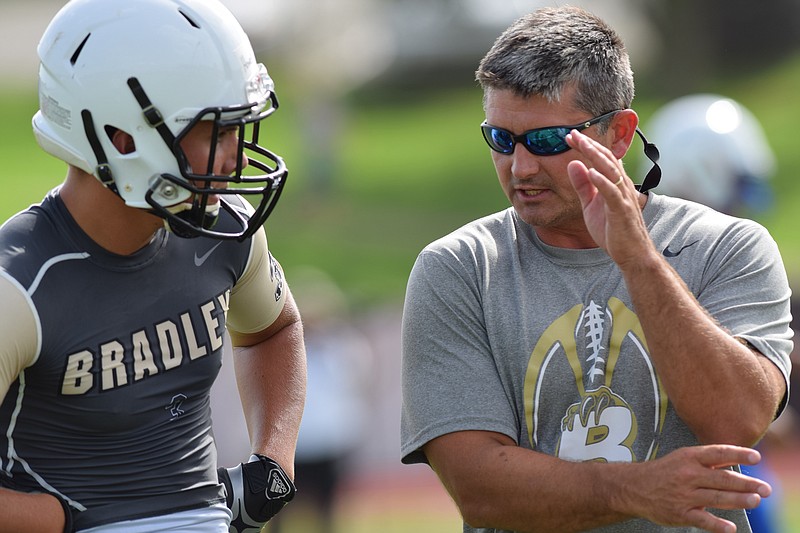 Bradley Central head coach Damon Floyd (right) discusses a play with wide receiver Nick Howell (3).  Ooltewah, Soddy-Daisy, Red Bank and Bradley Central took part in a 7 on 7 scrimmage at Ooltewah High School, July 8, 2015.