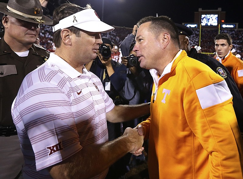 Oklahoma coach Bob Stoops, left, and Tennessee coach Butch Jones, right, shake hands after last year's game in Norman, Okla. The Sooners won 34-10.