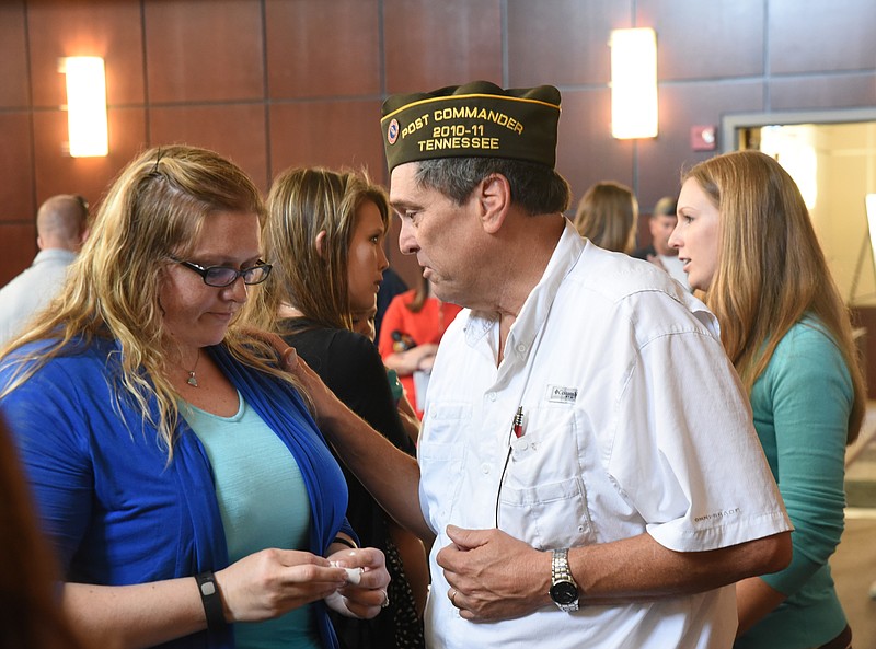 Lorri Wyatt, left, and Angie Smith, second from left, receive well wishes from VFW Cleveland Post 2598 representatives James Johnson, second from right, and Rebecca Wolfe following a Friday morning ceremony in the Chattanooga City Council meeting room.