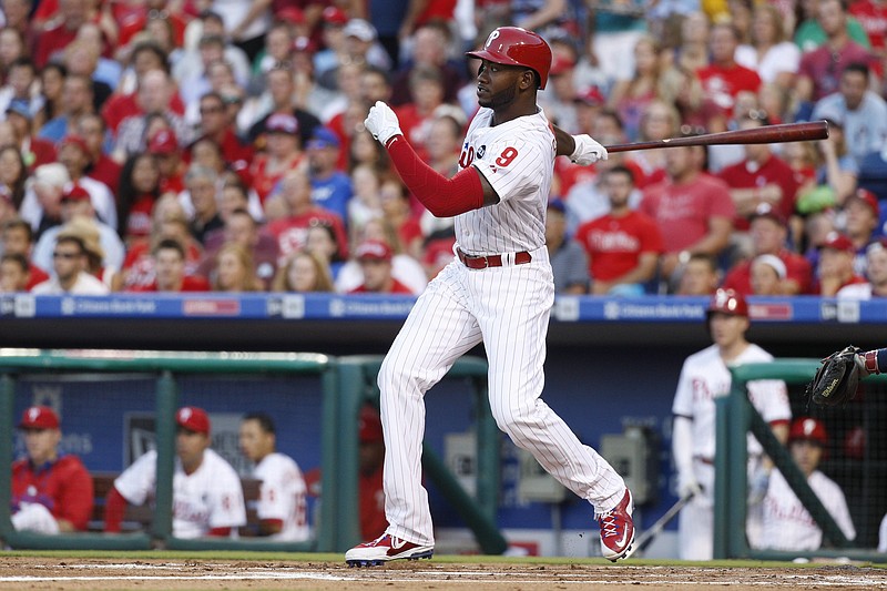 Philadelphia Phillies' Domonic Brown hits a single during the first inning of a baseball game against the Atlanta Braves on Friday, July 31, 2015, in Philadelphia.