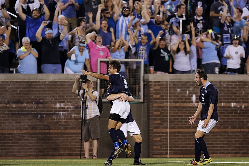 CFC players celebrate their second goal during Chattanooga FC's national semifinal match against the Indiana Fire at Finley Stadium on Saturday, Aug. 1, 2015, in Chattanooga.
