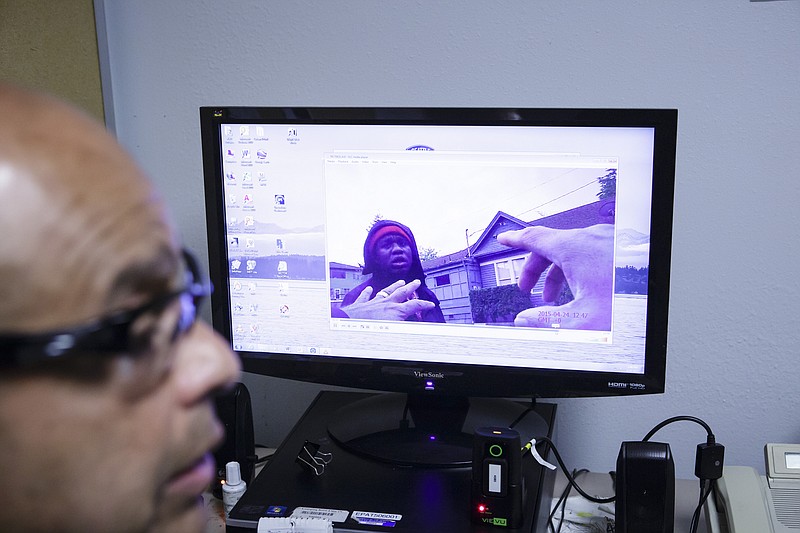 Officer Daniel Enriquez views footage taken with a body camera during his patrol in Seattle, last April. While some departments cite privacy concerns or the administrative burden of making the videos available to the public, the Seattle police post everything. (Evan McGlinn/The New York Times)