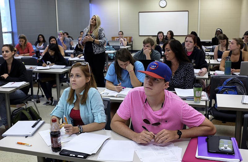 Mackenzie Marr, right, and Lydia Brink take notes from a powerpoint presentation during an Anatomy and Physiology 2 class at Chattanooga State Technical Community College on Friday, July 31, 2015, in Chattanooga, Tenn.