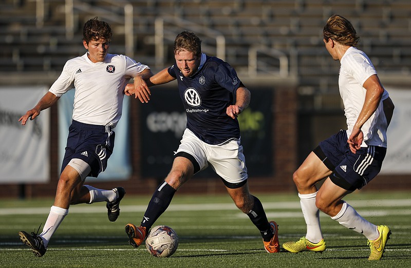 CFC's Luke Winter dribbles between Indiana Fire's Derek Creviston, left, and Tanner Wikken during Chattanooga FC's national semifinal match against the Indiana Fire at Finley Stadium on Saturday, Aug. 1, 2015, in Chattanooga, Tenn.