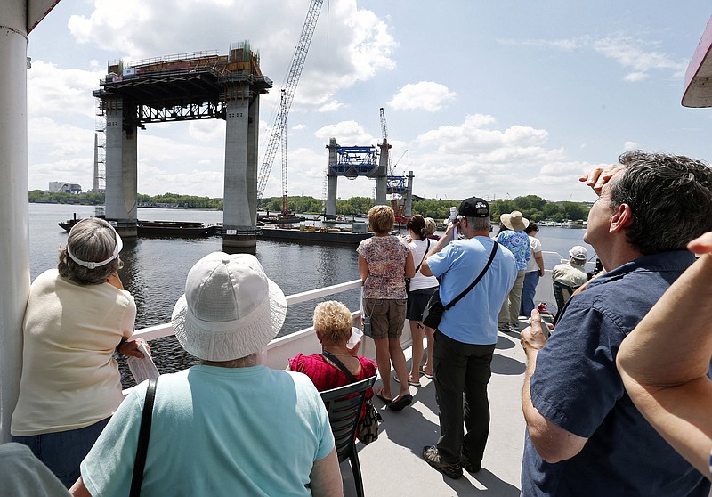 
              In this July 22, 2015 photo, people on the top deck of a river boat view piers toward the Minnesota side for the mile-long St. Croix Crossing bridge linking Minnesota and Wisconsin near Stillwater, Minn. Three times a month, 350 or more people head out on the 90-minute tours, with adults paying $10 apiece for the chance to view one of the biggest and most expensive bridge projects in Minnesota history. (AP Photo/Jim Mone)
            