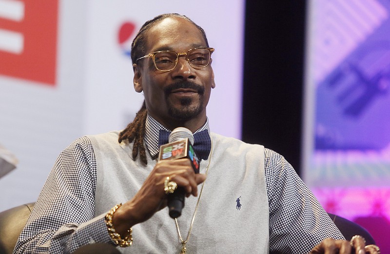 
              FILE - In this March 20, 2015 file photo, rapper Snoop Dogg takes part in the "Keynote Conversation with Snoop Dogg" at the South by Southwest festival in Austin, Texas.  Italian financial police said they stopped the rapper at the Lamezia Terme airport in Calabria on Saturday, Aug. 1, 2015 with $422,000 in cash, well above the limit that can legally be transported across EU borders undeclared. The incident comes less than a week after Snoop Dogg was briefly stopped in Sweden on suspicion of drug use after a concert near Stockholm. (Jack Plunkett/Invision via AP, File)
            