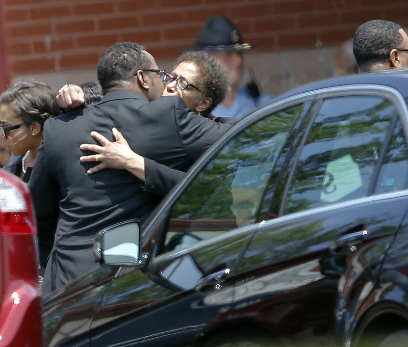 R&B singer Bobby Brown hugs an unidentified woman after a funeral service for his daughter, Bobbi Kristina Brown, Saturday, Aug. 1, 2015, in Alpharetta, Ga. Bobbi Kristina, the only child of Whitney Houston and Bobby Brown, died in hospice care July 26, about six months after she was found face-down and unresponsive in a bathtub in her suburban Atlanta townhome. 