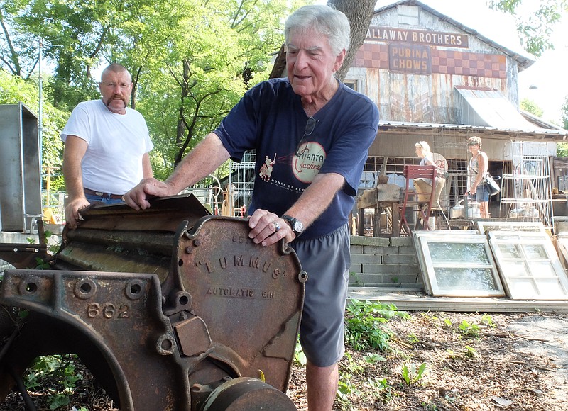 Danny Brown, left, listens as Jim Callaway talks about the cotton gin equipment from the 1920s outside the old Callaway Cotton Gin in downtown Ringgold. The family-owned old cotton gin dates back to 1929, and is located directly across the street from Ringgold City Hall.