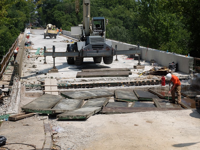 Taylor Voiles puts form oil on the steel forms to keep concrete from sticking to them as they are poured. The bridge over Interstate 24 on Missionary Ridge is nearing completion. More than 1,000-yards of concrete has been poured and the approaches to the bridge are about all that remain in the project.