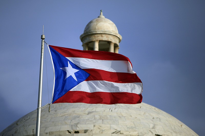 
              In this Wednesday, July 29, 2015 photo, the Puerto Rican flag flies in front of Puerto Rico’s Capitol as in San Juan, Puerto Rico. Nearly 10 years into a deep economic slump, Puerto Rico is no closer to pulling out, and, in fact, is poised to plummet further. The unemployment rate is above 12 percent and tens of thousands have migrated out of the island. (AP Photo/Ricardo Arduengo)
            