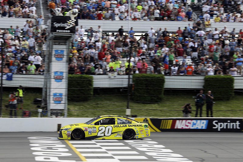 Matt Kenseth crosses the finish line to win the NASCAR Pocono 400 auto race, Sunday, Aug. 2, 2015, in Long Pond, Pa.