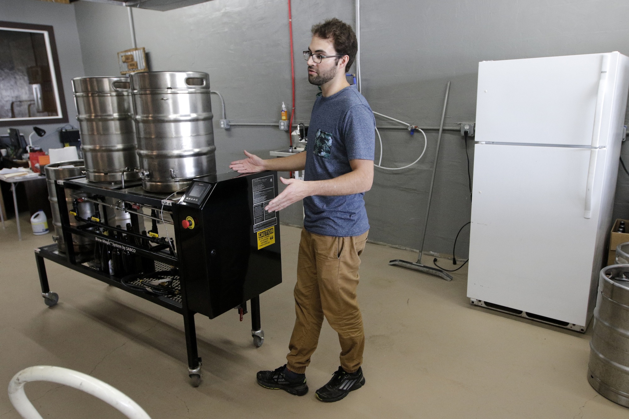 Brewer Kirby Garrison talks about his small setup for brewing beer Thursday, June 25, 2015, at new brewery Monkey Town Brewing Co. in Dayton, Tenn.