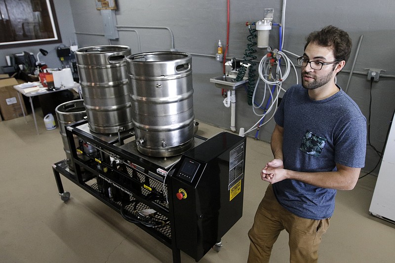 Brewer Kirby Garrison talks about his small setup for brewing beer Thursday, June 25, 2015, at new brewery Monkey Town Brewing Co. in Dayton, Tenn.