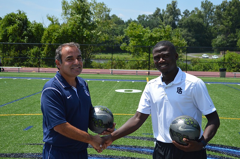 Dalton State soccer coach Kerem Daser, left, welcomes one of his former players, Rene Enang, as his assistant coach for the first Roadrunners team.