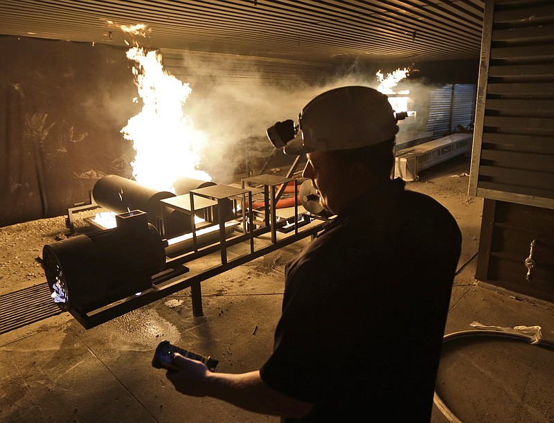 
              FILE - In this June 11, 2013 file photo, Garrett Tomblin operates a remote control that controls the fire in the mine disaster training area of Alpha Natural Resources' Running Right Leadership Academy in Julian, Va. Alpha Natural Resources Inc., one of the country's biggest coal producers, on Monday, Aug. 3, 2015 became the latest in a string of coal companies to seek bankruptcy protection amid an historic shift in the electric power sector brought on by cheap natural gas prices and pollution regulations. (AP Photo/Steve Helber, File)
            