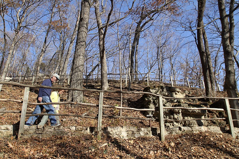 
              FILE - In this Nov. 8, 2010 file photo, Paul and Sue Schramm, of Dyersville, Iowa, hike one of the trails at Effigy Mounds National Monument in Harpers Ferry, Iowa. The National Park Service has shelved a blistering internal report that details a “decade of dysfunction” as the agency allowed dozens of illegal construction projects to cause significant damage to an ancient Iowa burial ground that Indian tribes consider sacred. (Justin Hayworth/The Des Moines Register via AP, file) NO SALES, MAGS OUT, TV OUT, MANDATORY CREDIT
            