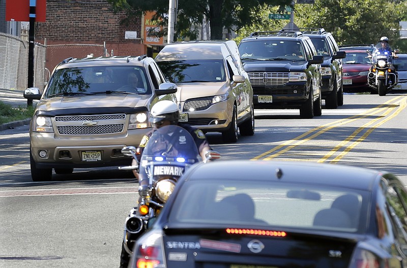 
              A gold colored hearse carrying the coffin bearing the body of Bobby Kristina Brown arrives with police escort at Whigham Funeral home in Newark, N.J., early Monday, Aug. 3, 2015. Bobbi Kristina, the only child of Whitney Houston and R&B singer Bobby Brown, died in hospice care July 26, about six months after she was found face-down and unresponsive in a bathtub in her suburban Atlanta townhome. (AP Photo/Mel Evans)
            