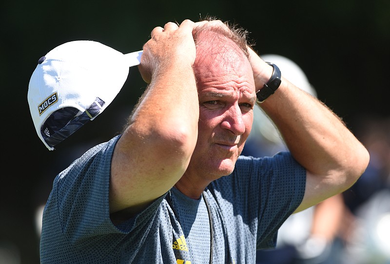 Coach Russ Huesman watches his team during the first day of football practice for the University of Tennessee at Chattanooga on Monday, Aug. 3, 2015, in Chattanooga.