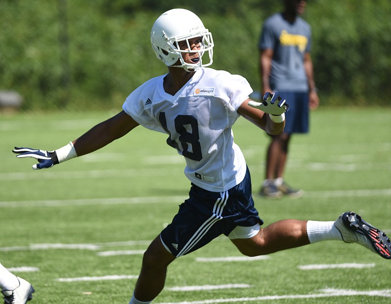 Receiver James Stovall turns to look for the ball during the first day of football practice for the University of Tennessee at Chattanooga on Monday, Aug. 3, 2015, in Chattanooga.