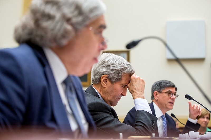 Secretary of State John Kerry, center, flanked by Treasury Secretary Jacob Lew, right, and Energy Secretary Ernest Moniz, left, pauses on Capitol Hill on July 28, 2015, as they testified before the House Foreign Affairs Committee hearing on the Iran Nuclear Agreement.