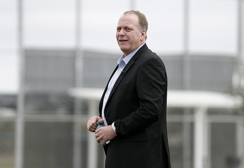 In this Feb. 25, 2015, file photo, baseball broadcast analyst and former Boston Red Sox pitcher Curt Schilling watches as the Red Sox workout at baseball spring training in Fort Myers Fla. 