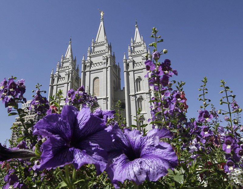 
              FILE - This Sept. 3, 2014, file photo shows flowers blooming in front of the Salt Lake Temple, at Temple Square, in Salt Lake City. The Mormon church is taking another step in its push to be more transparent, and is releasing more historical documents that shed light on how Joseph Smith formed the religion. The Church of Jesus Christ of Latter-day Saints says the volume being scheduled to be released at a news conference Wednesday in Salt Lake City is a printer's manuscript of the Book of Mormon. (AP Photo/Rick Bowmer, File)
            