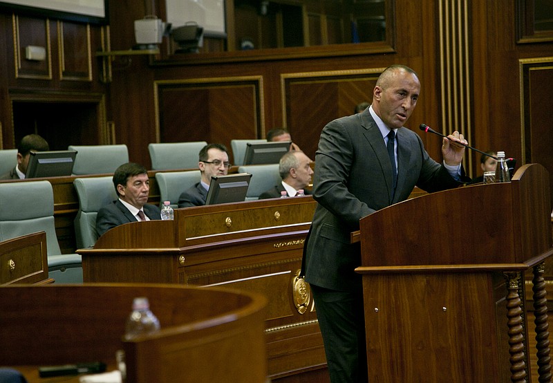 
              Member of the opposition Ramush Haradinaj addresses Kosovo lawmakers during a debate passing constitutional amendments that would allow the establishment of a special court to prosecute its top leaders and former guerrilla fighters for war crimes in capital Pristina on Monday, Aug. 3, 2015. Kosovo's Parliament on Monday approved a constitutional amendment to set up a special court to prosecute former leaders over war crimes, including the killing of hundreds of Serb civilians. (AP Photo/Visar Kryeziu)
            