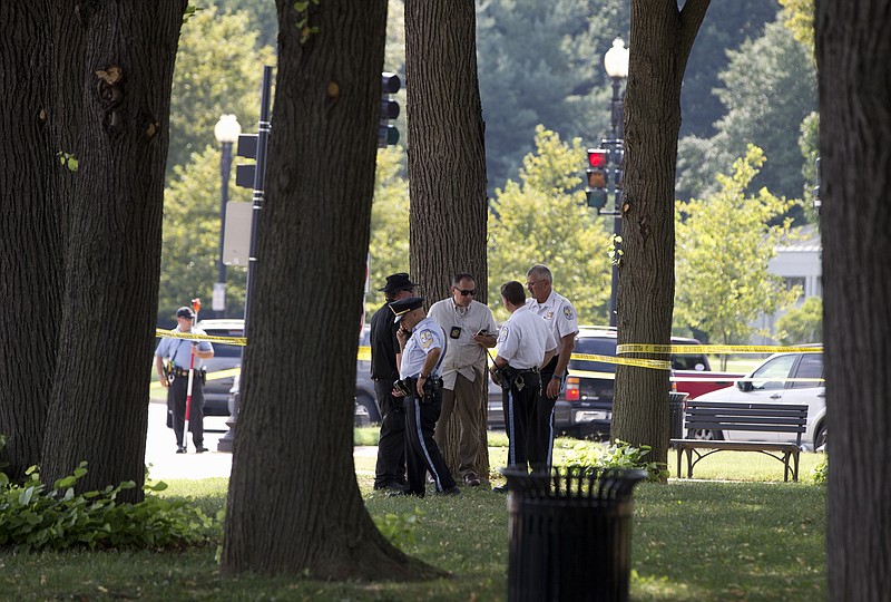 Law enforcement officers gather at the site of a reported shooting near the National Mall in Washington on Tuesday, Aug. 4, 2015. 