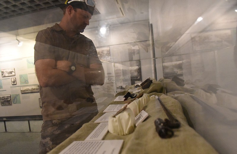 Jeremy Miller from LaFayette, Ind., looks at a display case of Civil War artifacts, most of which were donated by local citizens, at the Chickamauga Battlefield Visitor's Center on Wednesday, Aug. 5, 2015, near Fort Oglethorpe, Ga. 
