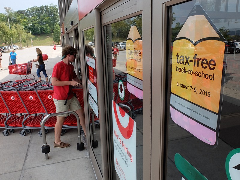 Dylan Satterwhite returns carts to the store as a shopper leaves Target in Hixson on Thursday afternoon. Friday and Saturday, shoppers will enjoy a tax free experience before school begins.
