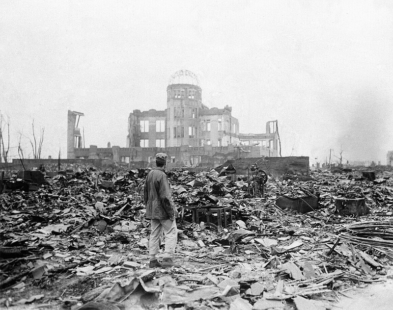 
              FILE - In this Sept. 8, 1945 file photo, an allied correspondent stands in the rubble in front of the shell of a building that once was a exhibition center and government office  in Hiroshima, Japan, a month after the first atomic bomb ever used in warfare was dropped by the U.S. on Aug. 6, 1945. (AP Photo/Stanley Troutman, File)
            