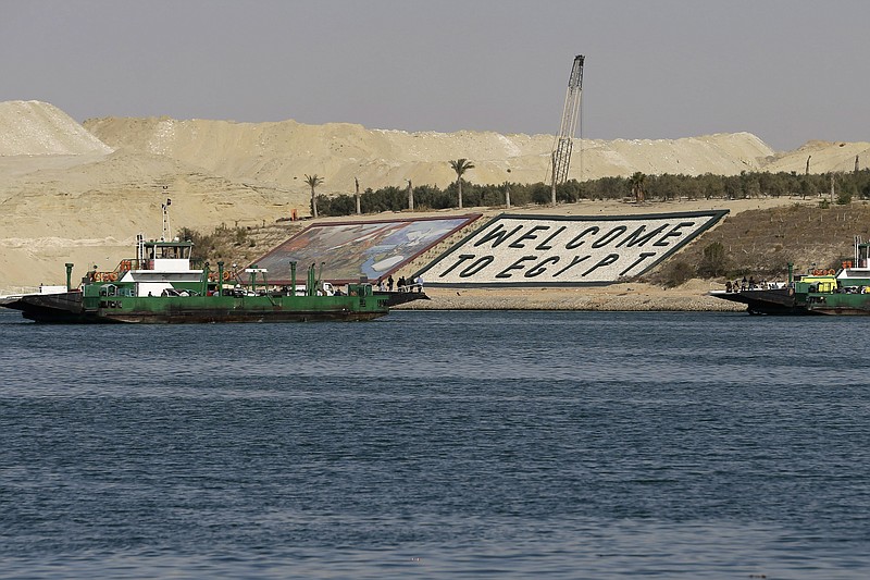 
              FILE - In this Feb. 4, 2015 file photo, ferries cross the Suez Canal during a media tour in Ismailia, Egypt. Egypt on Thursday, Aug. 6, will unveil a major extension of the Suez Canal, a mega-project that has emerged as a cornerstone of President Abdel-Fattah el-Sissi’s efforts to restore national pride and revive the economy after years of unrest. (AP Photo/Hassan Ammar, File)
            