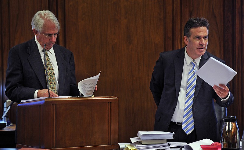 Attorney Stephen Kissinger, left, looks over evidence as Assistant Attorney General Scott Sutherland talks with Chancellor Claudia Bonnyman during a trial, Tuesday, July 7, 2015, in Nashville, Tenn. After more than a year of delays, a trial challenging Tennessee's method for executing prisoners began on Tuesday with Lubarsky, an anesthesiologist, suggesting that inmates given high doses of lethal injection drugs could spontaneously recover, although that was unlikely.