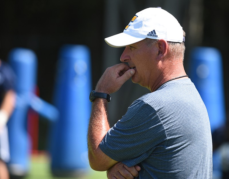 Coach Russ Huesman watches his team during the first day of football practice for the University of Tennessee at Chattanooga on Monday, Aug. 3, 2015, in Chattanooga.