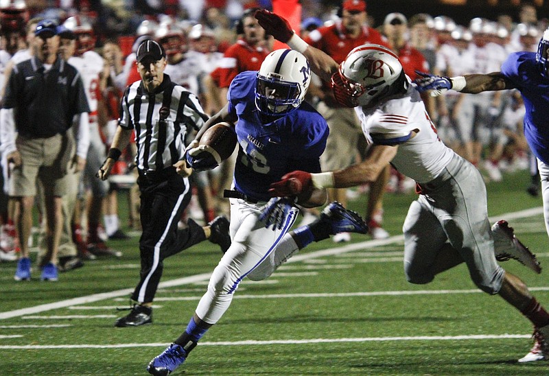 Baylor's Ryan Parker chases McCallie's Shawn McColley after he picked up a fumble during the rivalry matchup last season at Spears Stadium. The Red Raiders and Blue Tornado are both doing some rebuilding of their offensive and defensive lines as they prepare to kick off their 2015 schedules.