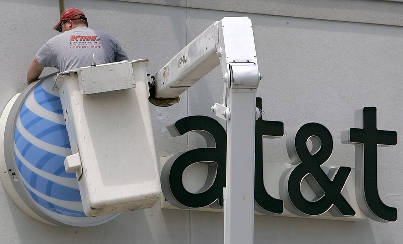 An AT&T sign is installed replacing what had been a Cingular sign on a wireless telephone store in Little Rock, Ark., in this 2007 file photo. 