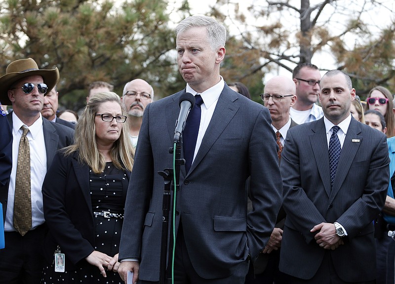 
              District Attorney George Brauchler speaks with members of the media following the reading of the jury's decision for Colorado theater shooter James Holmes, outside the Arapahoe County District Court in Centennial, Colo., Friday, Aug. 7, 2015. Holmes will be sentenced to life in prison without parole after a jury failed to agree on whether he should get the death penalty. (AP Photo/Brennan Linsley)
            